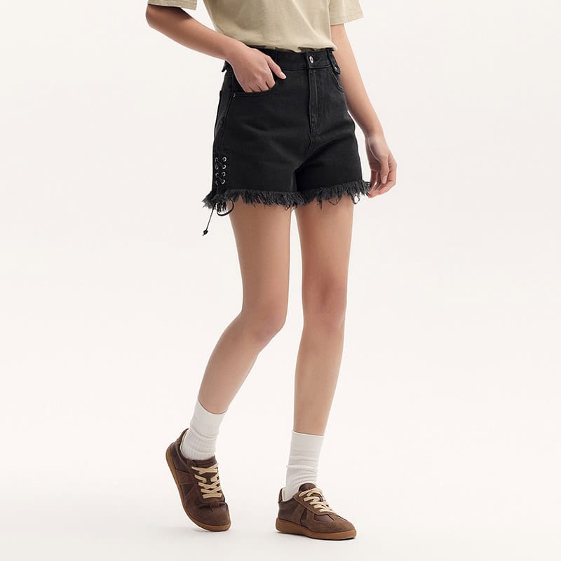Comfortable black denim shorts with distressed hem and lace-up detail, perfect for casual summer outfits. Suitable for women seeking stylish, trendy, and breathable summer wear.