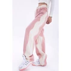 Comfortable wide-leg denim pants with distressed details, perfect for casual and trendy looks. Suitable for fashion-forward women seeking unique, stylish apparel.