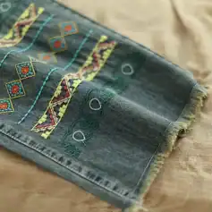 Brightly colored embroidered denim scarf featuring intricate patterns, perfect for adding a unique touch to fashion accessories and everyday outfits.
