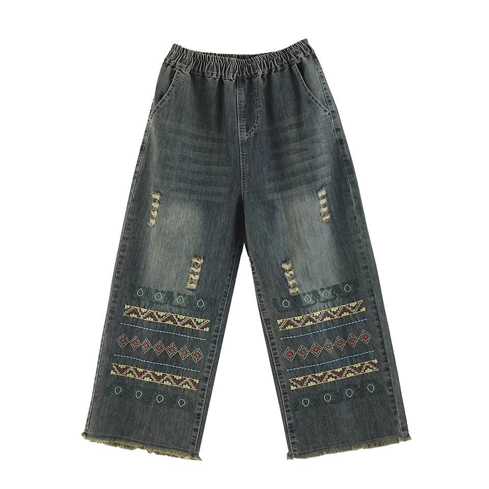 Casual distressed denim pants with colorful embroidery, ripped details, and a loose fit, perfect for trendy, comfortable style and streetwear fashion.