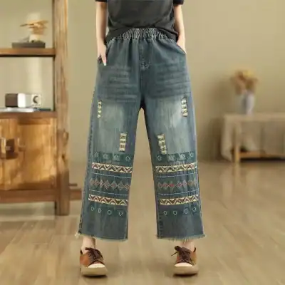 Comfortable wide-leg denim pants with embroidered and distressed details, perfect for casual wear and stylish outings.