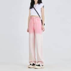 A young woman modeling trendy pink and white gradient wide-leg pants for modern fashion and casual wear. Perfect for stylish outings, emphasizing comfort and stylish appeal.