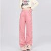 Comfortable pink ripped jean pants with wide-leg cut, stylish distressed details, and embroidery accents, ideal for casual fashion and streetwear looks.
