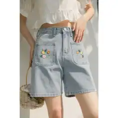 Embroidered denim shorts with floral details, perfect for summer casual wear. Comfortable and stylish, ideal for outdoor activities and beach outfits.