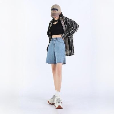 Modern casual streetwear look for women, featuring trendy denim skirt, black crop top, oversized plaid shirt, and stylish sneakers, perfect for everyday fashion.