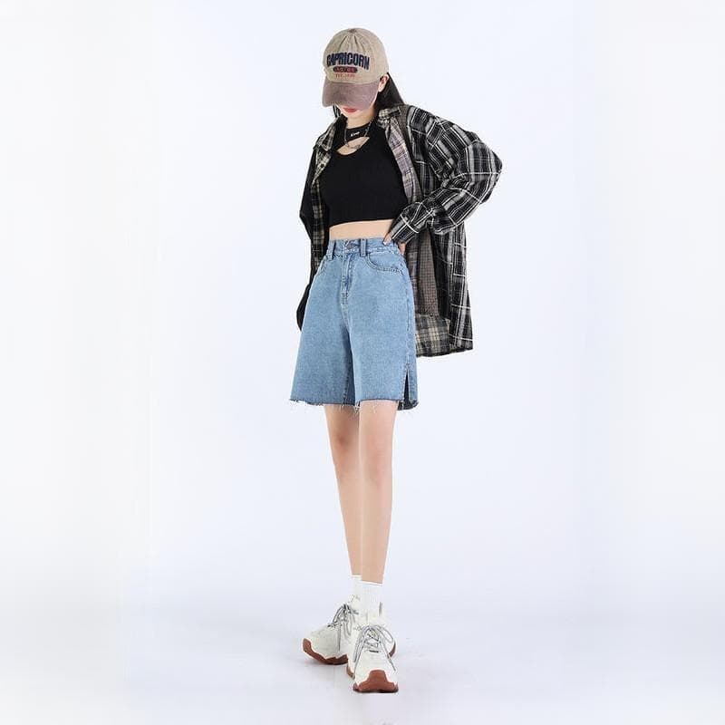 Modern casual streetwear look for women, featuring trendy denim skirt, black crop top, oversized plaid shirt, and stylish sneakers, perfect for everyday fashion.