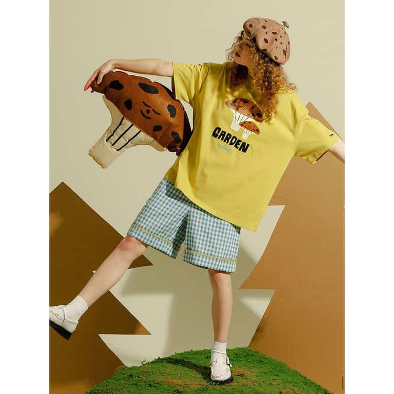 Colorful kids fashion with playful mushroom graphic t-shirt, checkered shorts, and fun accessories from Monalisa Store. Perfect for stylish children’s clothing needs.