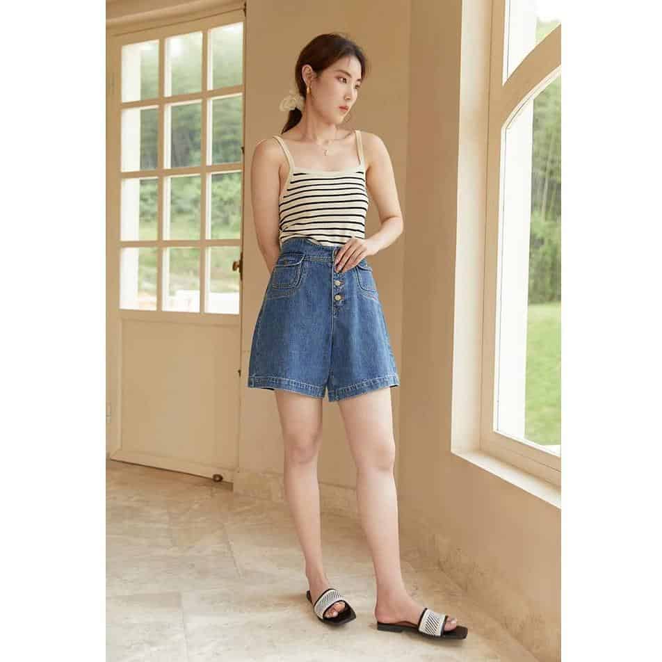 Stylish high-waisted denim shorts perfect for summer casual wear. Comfortable fit with button closure, ideal for women seeking fashionable and versatile wardrobe essentials.