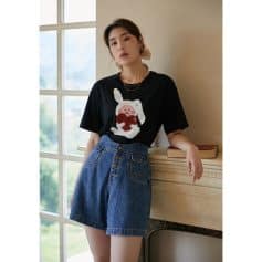 A stylish black women's T-shirt featuring a cute bunny holding a heart, perfect for casual wear and elevating your everyday wardrobe.