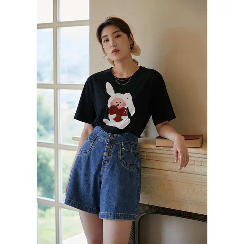 A stylish black women's T-shirt featuring a cute bunny holding a heart, perfect for casual wear and elevating your everyday wardrobe.