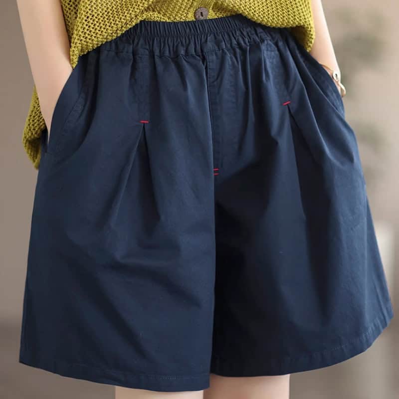 Comfortable navy blue shorts with an elastic waistband and relaxed fit, perfect for casual, everyday wear or summer fashion.