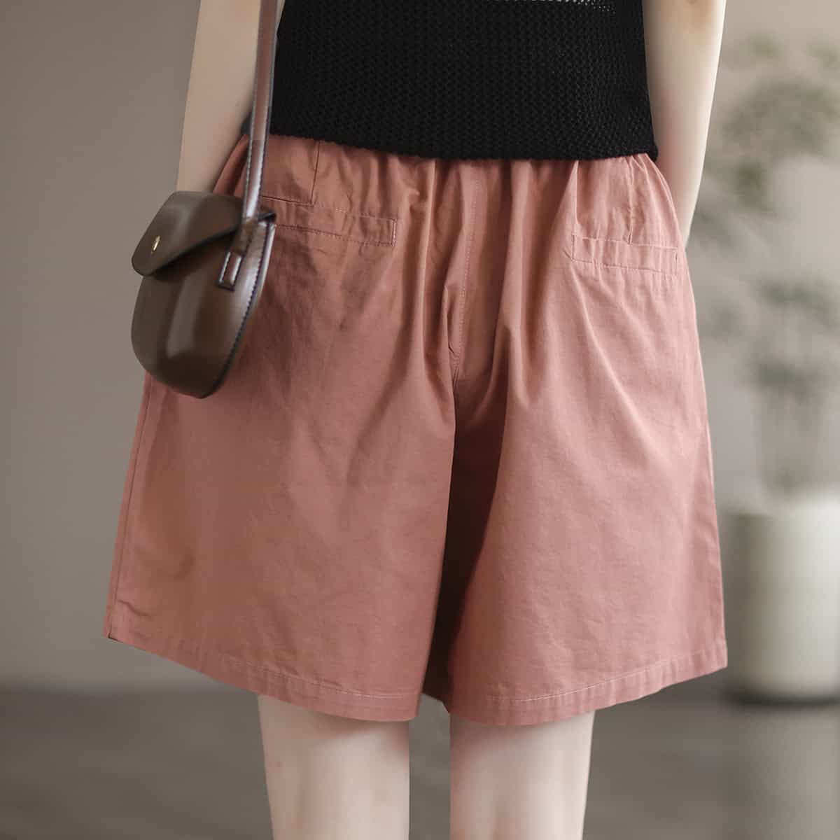 A stylish pair of pink shorts with a loose fit, featuring side pockets and a comfy waistband, perfect for casual wear or outdoor activities. Made from soft, breathable fabric for all-day comfort.