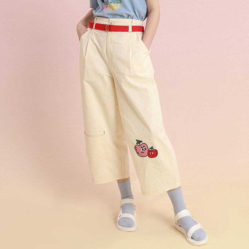 Cute embroidered fruit patch on wide-leg cream pants with pockets, stylish and comfortable for everyday wear. Perfect for fashion-forward casual outfits.