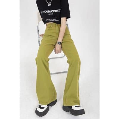 Close-up of trendy yellow high-waisted wide-leg pants worn by a woman, paired with chunky sneakers and a black graphic t-shirt, emphasizing fashionable casual wear suitable for shopping or outings.