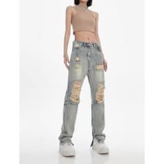 Stylish ripped denim jeans with a relaxed fit, perfect for casual fashion statements. Features heavily distressed details and a vintage wash for a trendy, edgy look.