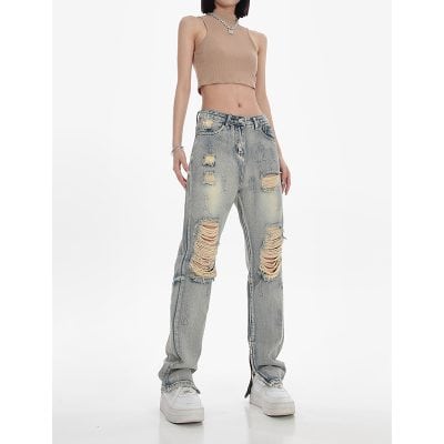 Stylish ripped denim jeans with a relaxed fit, perfect for casual fashion statements. Features heavily distressed details and a vintage wash for a trendy, edgy look.
