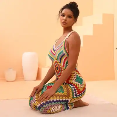 Vibrant crochet dress worn by a woman, showcasing bohemian and artistic fashion, perfect for summer and resort wear.