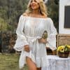 Vintage white beach cover-up with lace sleeve details and tie waist for a stylish summer look. Perfect for seaside vacations and poolside lounging.