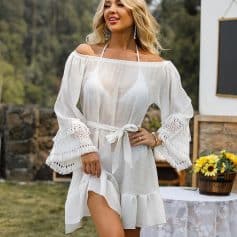 Vintage white beach cover-up with lace sleeve details and tie waist for a stylish summer look. Perfect for seaside vacations and poolside lounging.