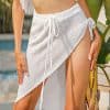 Elegant white knit beach wrap skirt for women featuring a side slit, adjustable drawstring, and comfortable fit, perfect for beach vacations, poolside lounging, and summer resort style.