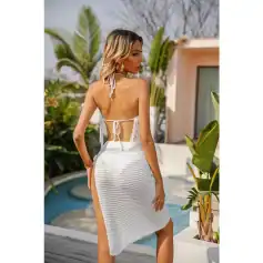 Stylish white summer dress with open back and side slit, perfect for beach or resort wear, combining comfort and fashion.