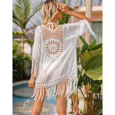 Stylish white beach cover-up with crochet design and fringe detail. Perfect for beach or poolside look, offering a chic and breathable summer style.