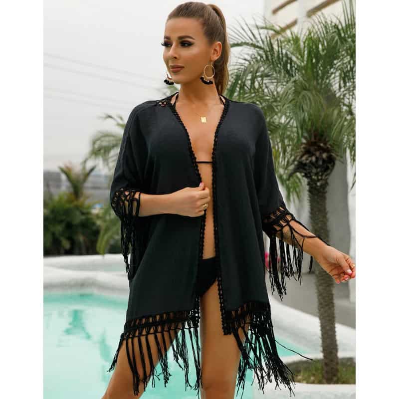 Elegant black beach cover-up with lace and fringe details, perfect for poolside or seaside walks, enhancing your poolside or vacation look with style and comfort.