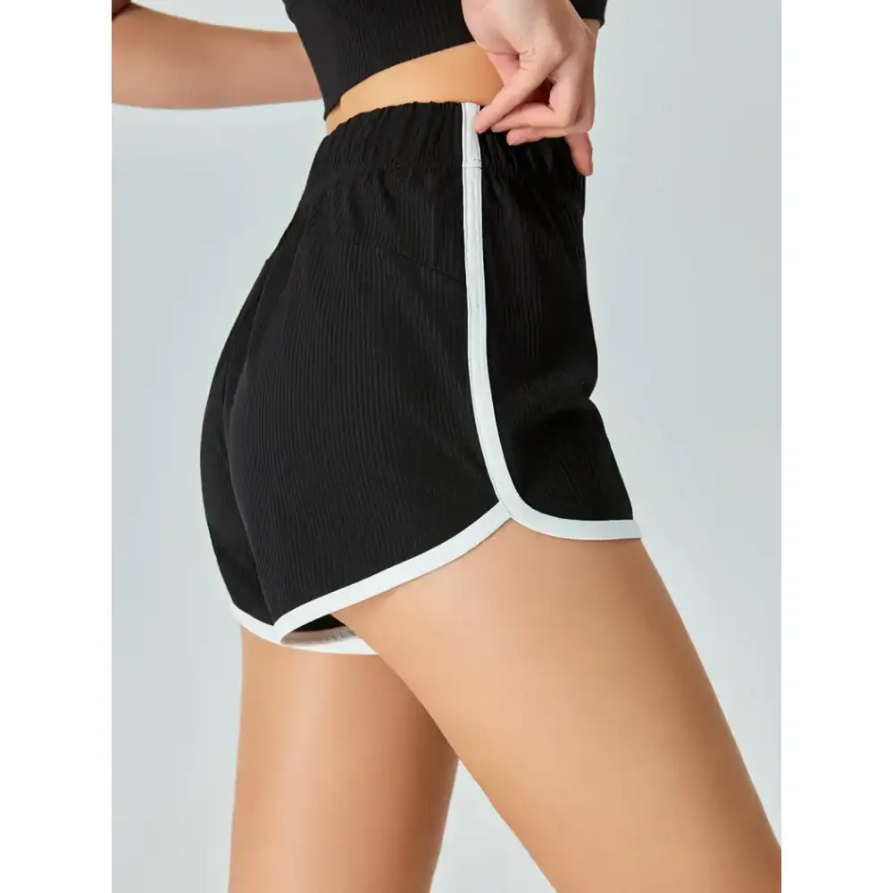Comfortable black athletic shorts with white trim, perfect for sports or casual wear, featuring a flexible waistband and lightweight fabric.