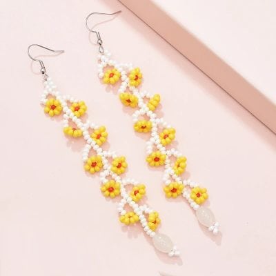 Bright yellow and white floral beaded earrings, perfect for accessory styling and fashion statements. Handcrafted jewelry ideal for casual and party wear.