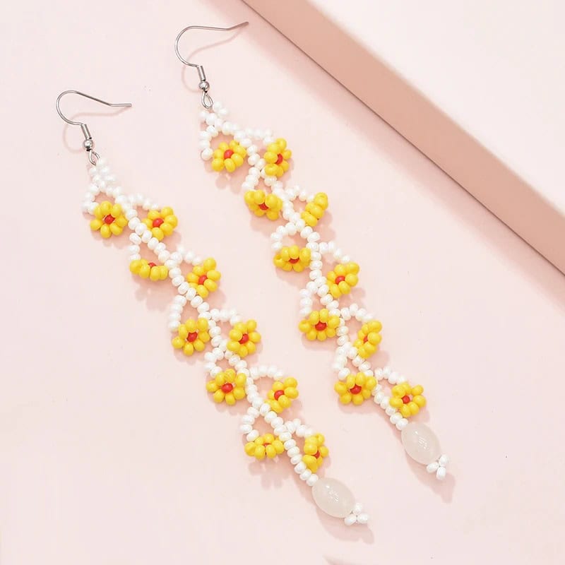 Bright yellow and white floral beaded earrings, perfect for accessory styling and fashion statements. Handcrafted jewelry ideal for casual and party wear.