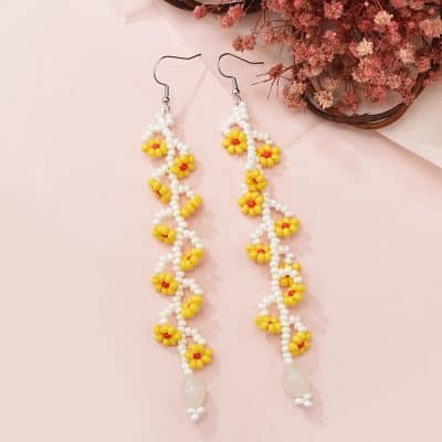 Delightful handmade beaded earrings featuring yellow daisy flowers, perfect for a fresh, feminine look. Made with high-quality white beads and floral accents, ideal for everyday wear or special occasions.