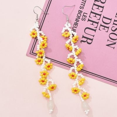 Bright yellow and white beaded floral earrings with dangling design, perfect for stylish accessories or gift ideas.