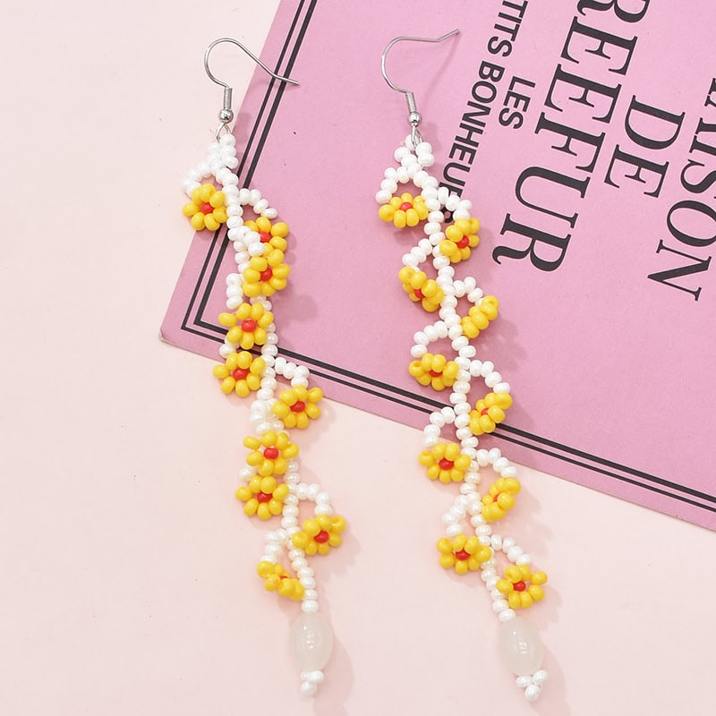Bright yellow and white beaded floral earrings with dangling design, perfect for stylish accessories or gift ideas.