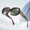 Tortoise shell sunglasses with green tinted lenses, trendy eyewear accessory, perfect for UV protection, stylish for sunny days, from Monalisa Store.