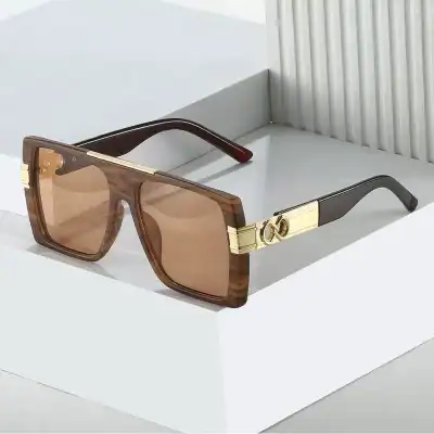 Stylish designer sunglasses with brown tinted lenses, gold accents, and a modern frame—perfect for high-end fashion and eye protection.