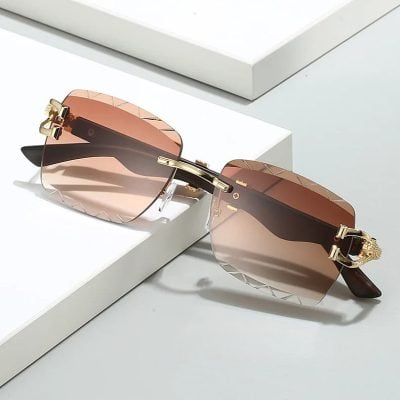 Elegant rose gold fashion sunglasses with rimless design, gradient lenses, and decorative gold accents, perfect for stylish eye protection and sun shielding.