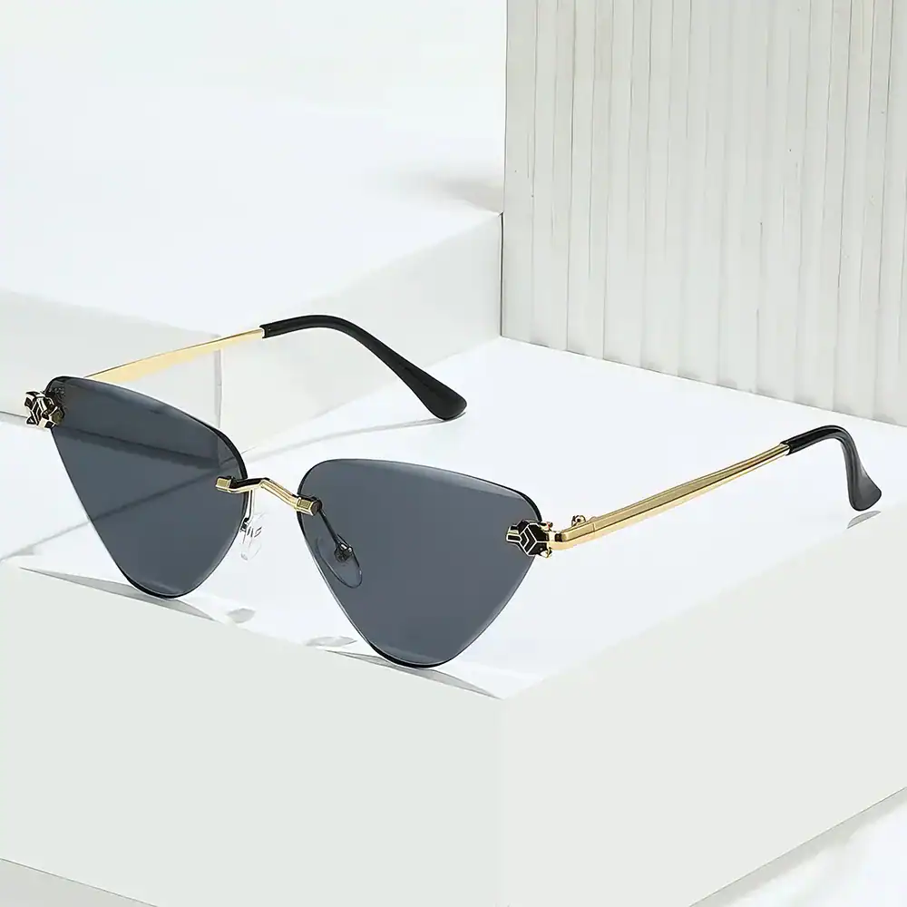 Luxury sunglasses with black tinted lenses, gold metallic arms, and sleek design, available at Monalisa Store for fashionable sun protection and statement style.