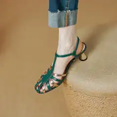 Stylish women’s green and gold T-strap high heels with a unique heel design, perfect for fashionable occasions and outdoor wear.