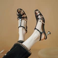 Stylish black and metallic strappy high-heeled sandals perfect for fashionable women’s footwear. Comfortable and chic, ideal for special occasions or upscale events.