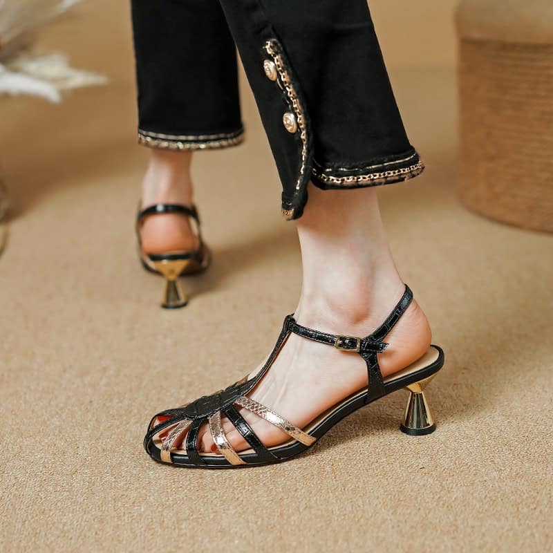 Elegant black t-strap high heels with metallic accents, perfect for fashion-forward women. Comfortable and chic, ideal for formal occasions or upscale outings.