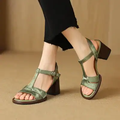 Stylish green open-toe sandals with ankle straps and chunky heels, perfect for summer and casual wear.