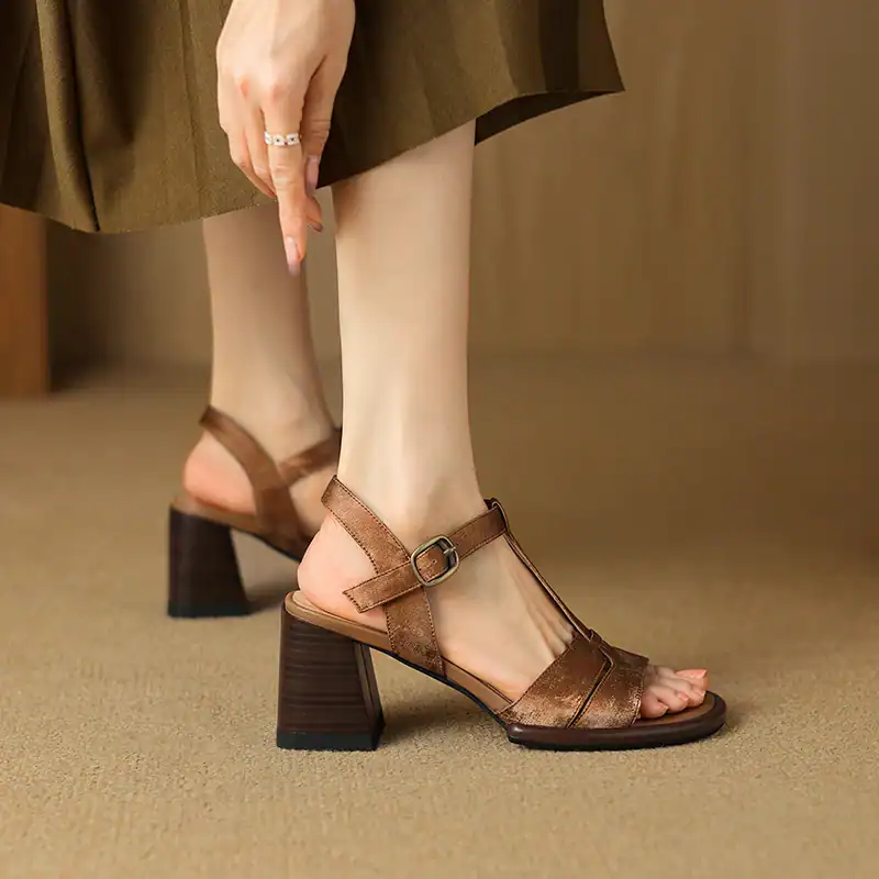 Elegant leather sandals featuring a sturdy block heel and adjustable ankle strap, perfect for stylish women seeking comfort and sophistication.