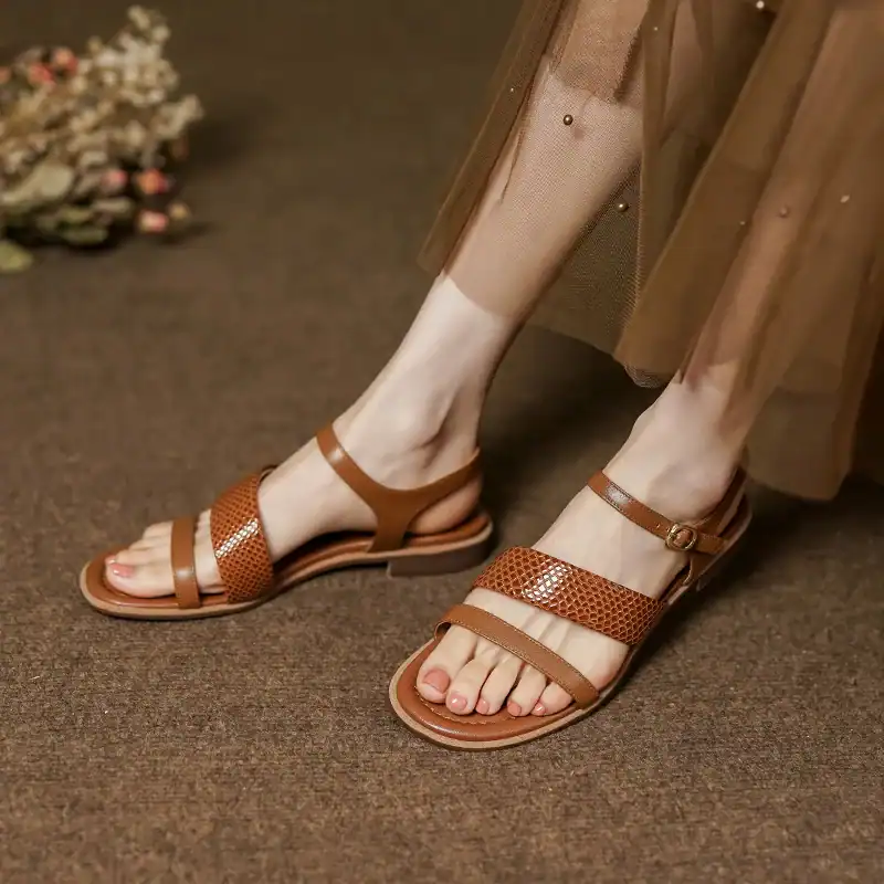 Elegant brown women's sandals with breathable straps and adjustable ankle closure, perfect for casual and summer wear.