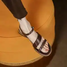 Elegant brown leather strap sandal with open toe design, ideal for fashion-forward women. Perfect for casual or dressy occasions, combining comfort and style.