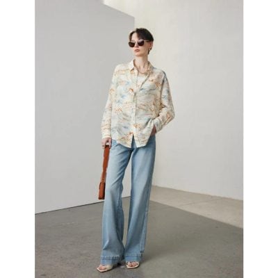 Fashionable woman wearing trendy sunglasses, pastel shirt, and wide-leg jeans, showcasing modern casual fashion from Monalisa Store for style-conscious shoppers.