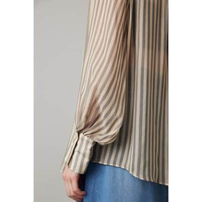 Elegant beige and brown striped women’s blouse, perfect for office or casual wear, featuring relaxed fit and stylish design.