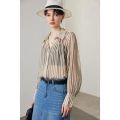 Elegant striped women's blouse with long sleeves, stylish collar, and sheer fabric, perfect for casual or formal look. Suitable for fashion-forward women seeking trendy clothing.
