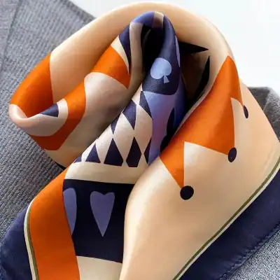 Elegant silk scarf with vibrant geometric and abstract patterns, perfect for stylish outfits and sun protection.