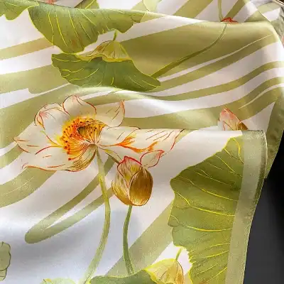 Elegant floral fabric with lotus flowers and leaves, perfect for home decor and crafts. Bright, durable material showcasing detailed botanical design.