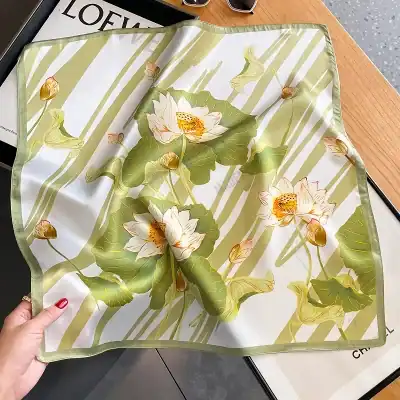 Luxurious silk scarf with detailed lotus flower and leaf design, perfect for fashion and accessories. Crafted with high-quality material, ideal for elegance and style.